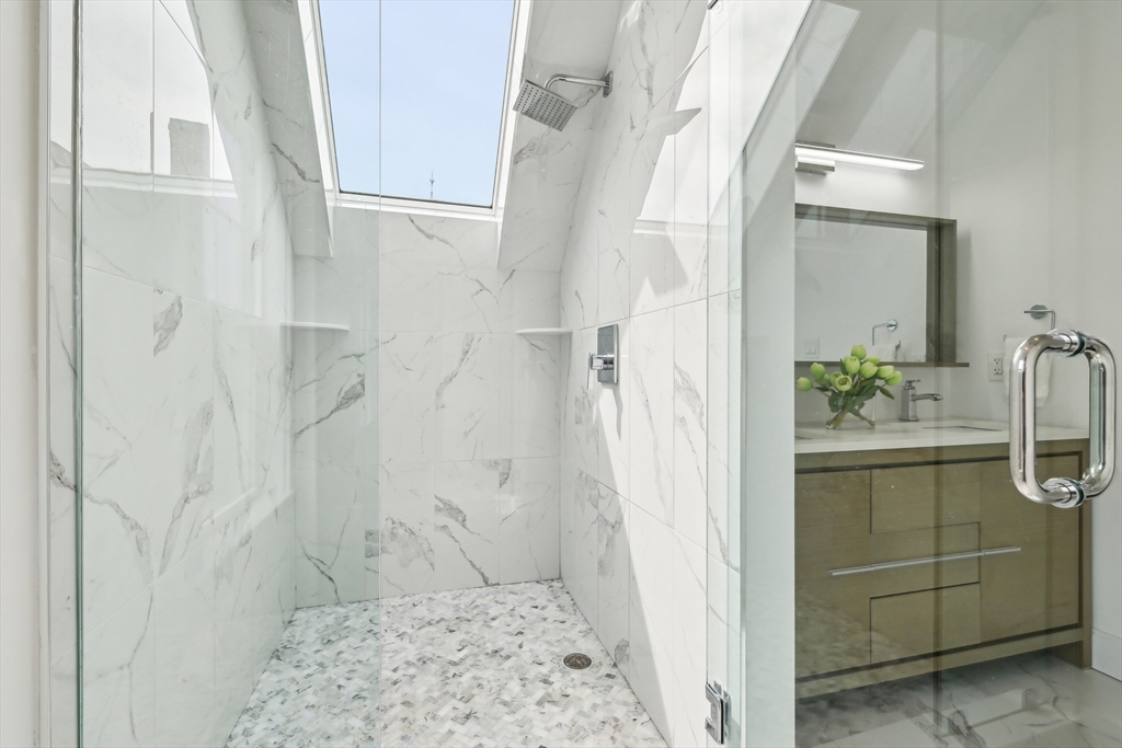 26 Robinson Street, Unit 26 Somerville, MA 02145 - Photo 13 of 29 a bathroom with a granite countertop shower a sink and a mirror