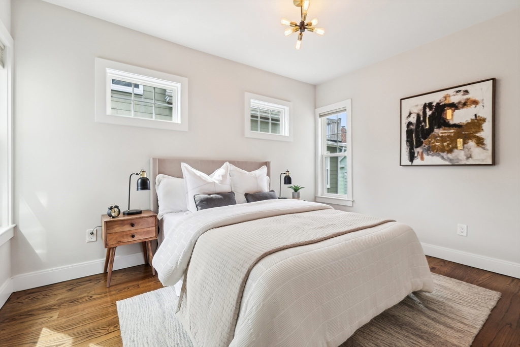 26 Robinson Street, Unit 26 Somerville, MA 02145 - Photo 14 of 29 a bedroom with bed and a painting on the wall