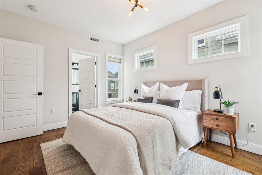 26 Robinson Street, Unit 26 Somerville, MA 02145 - Photo 15 of 29 a spacious bedroom with a bed and a table
