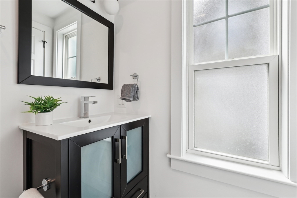 26 Robinson Street, Unit 26 Somerville, MA 02145 - Photo 16 of 29 a bathroom with a sink vanity and a mirror