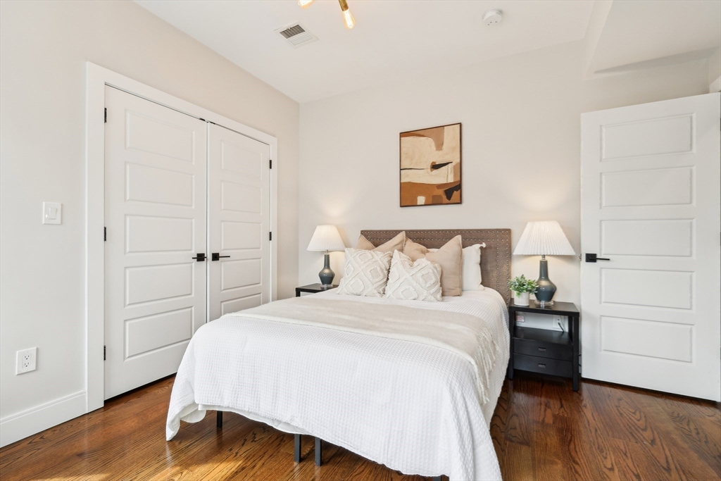 26 Robinson Street, Unit 26 Somerville, MA 02145 - Photo 18 of 29 a bedroom with a bed and a night stand