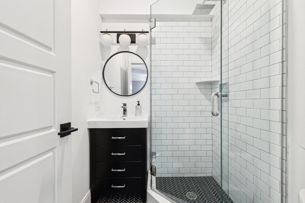 26 Robinson Street, Unit 26 Somerville, MA 02145 - Photo 21 of 29 a bathroom with a sink a toilet and shower