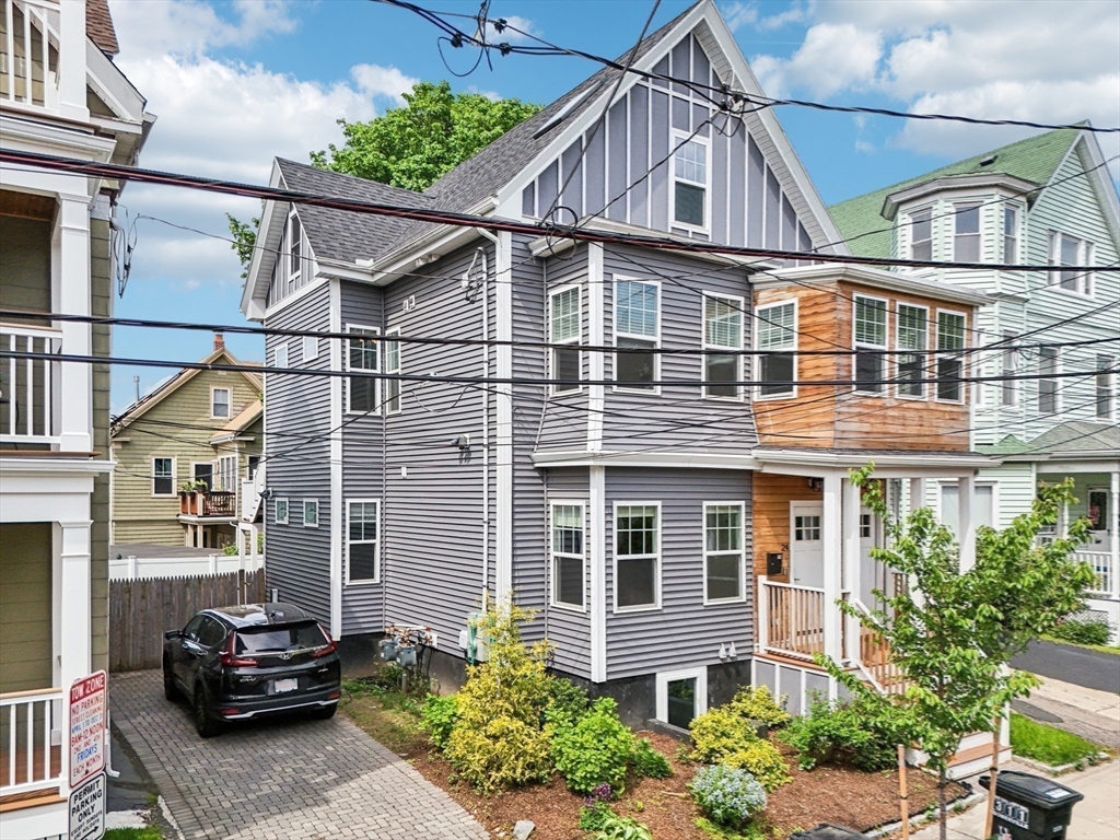 26 Robinson Street, Unit 26 Somerville, MA 02145 - Photo 25 of 29 a front view of a house with a garden