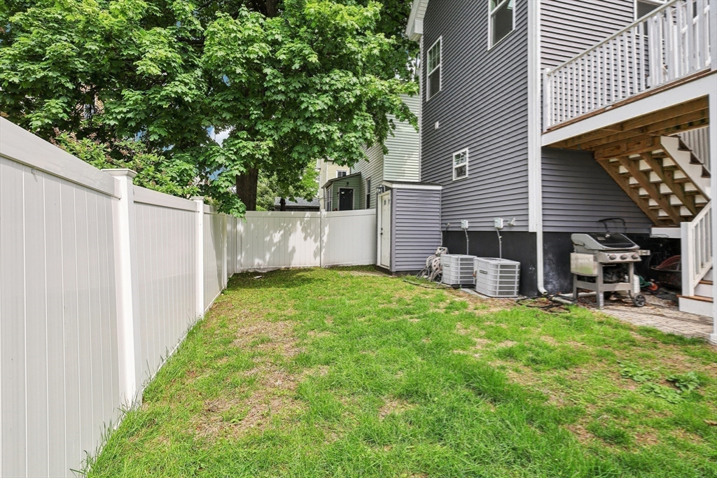 26 Robinson Street, Unit 26 Somerville, MA 02145 - Photo 26 of 29 a view of a chair and table in backyard of the house