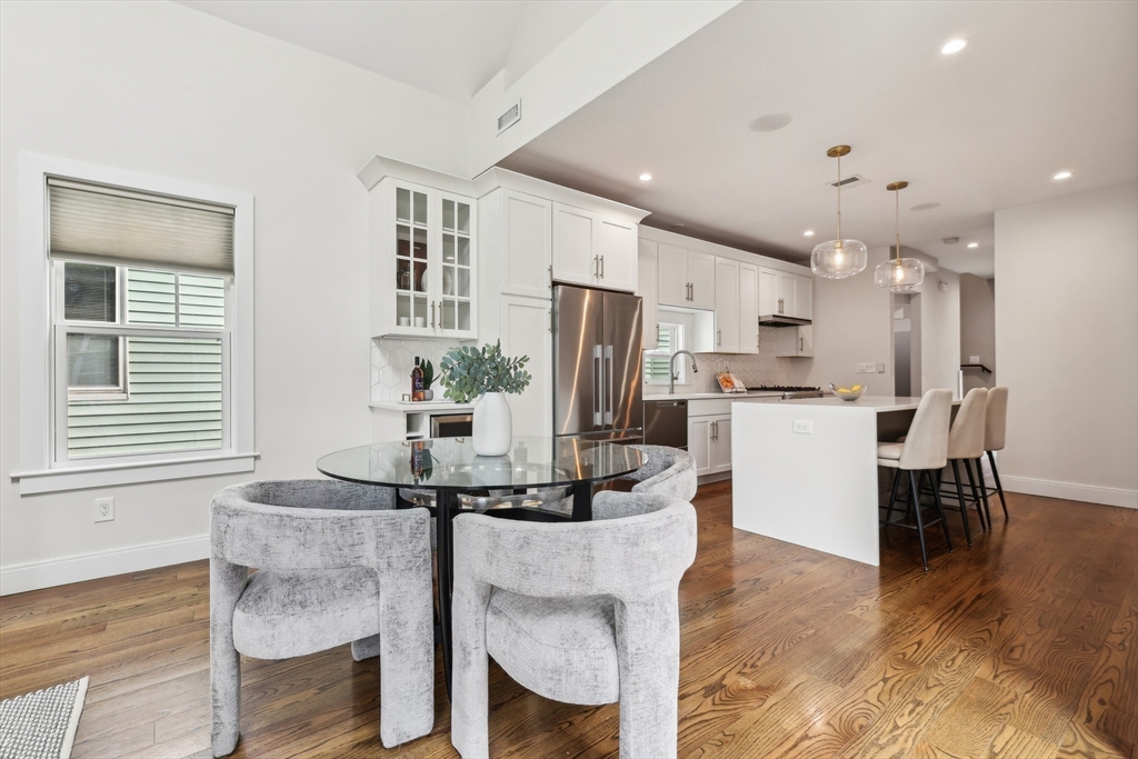 26 Robinson Street, Unit 26 Somerville, MA 02145 - Photo 5 of 29 a kitchen with stainless steel appliances kitchen island granite countertop a refrigerator and a stove top oven