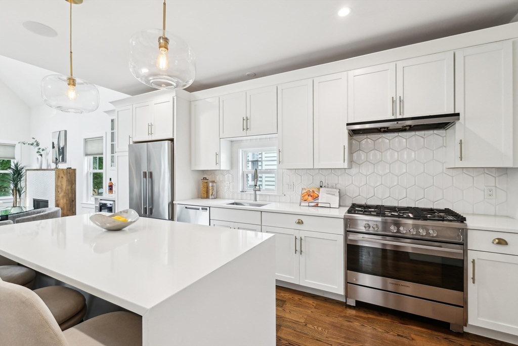 26 Robinson Street, Unit 26 Somerville, MA 02145 - Photo 7 of 29 a kitchen with stainless steel appliances and white cabinets