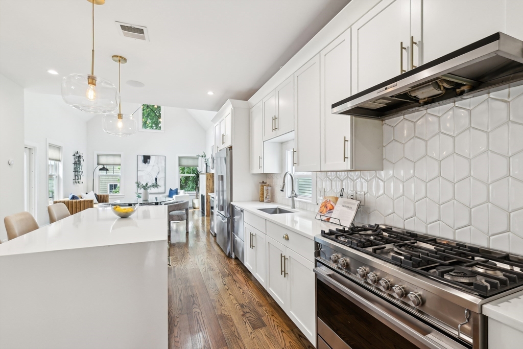 26 Robinson Street, Unit 26 Somerville, MA 02145 - Photo 8 of 29 a kitchen with stainless steel appliances a stove a sink and a refrigerator