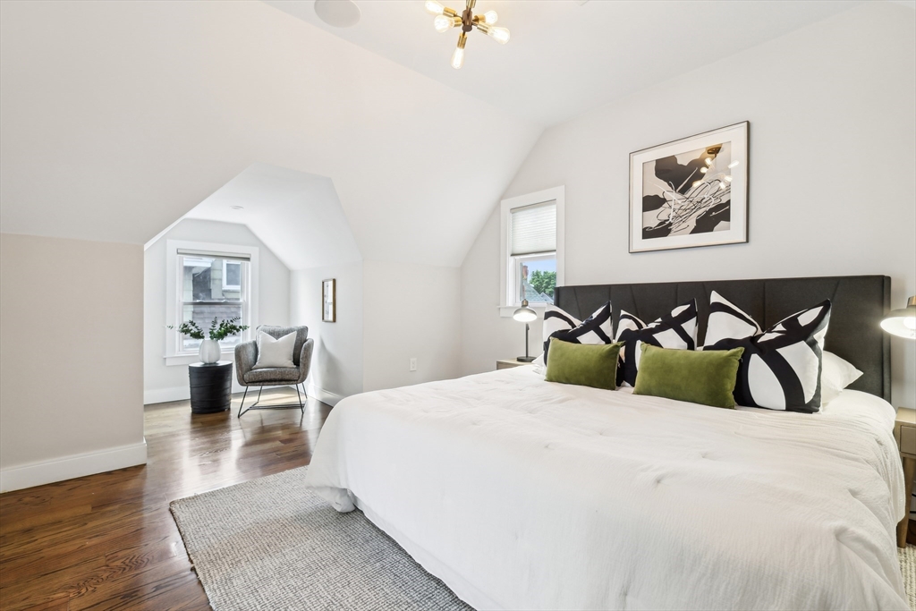 26 Robinson Street, Unit 26 Somerville, MA 02145 - Photo 9 of 29 a bedroom with a large bed and a painting on the wall