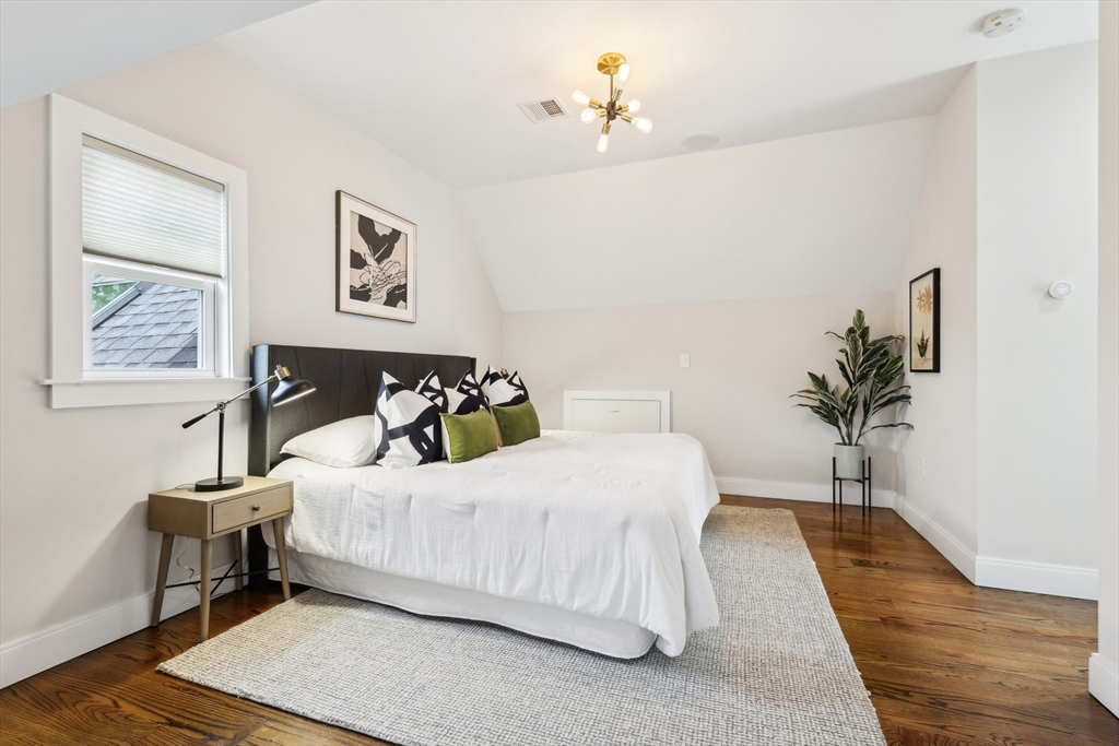 26 Robinson Street, Unit 26 Somerville, MA 02145 - Photo 10 of 29 a bedroom with a bed and a potted plant