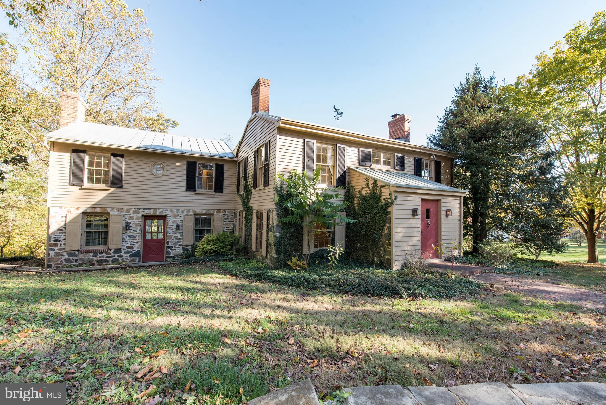3645 Macalpine Road Ellicott City, MD 21042 - Photo 2 of 30 a front view of house with yard and trees in the background