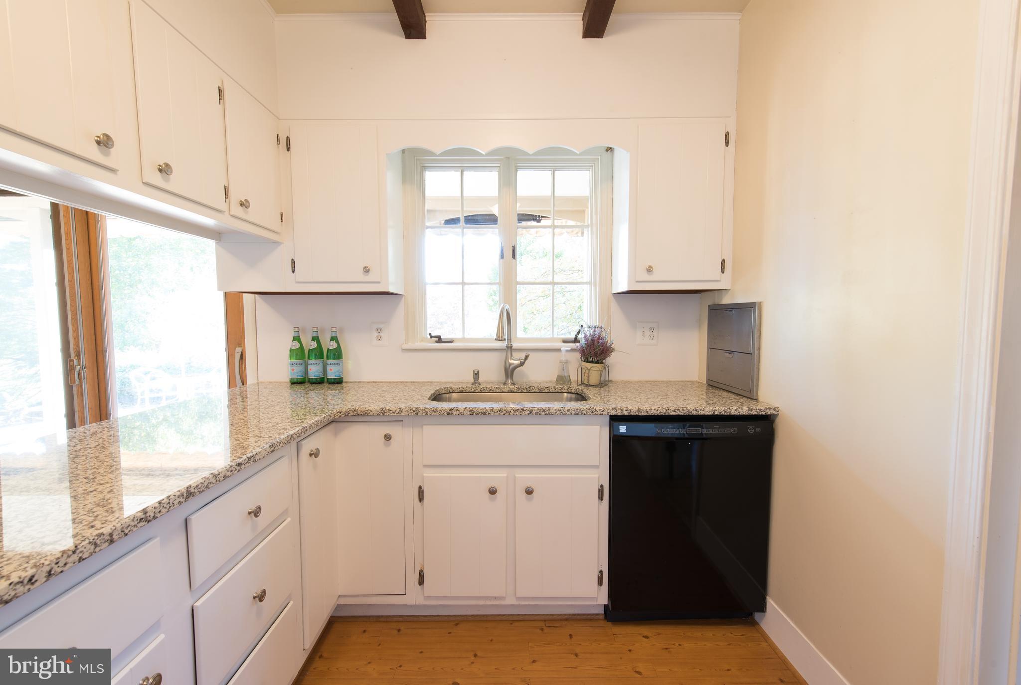 3645 Macalpine Road Ellicott City, MD 21042 - Photo 12 of 30 a kitchen with granite countertop white cabinets and a window