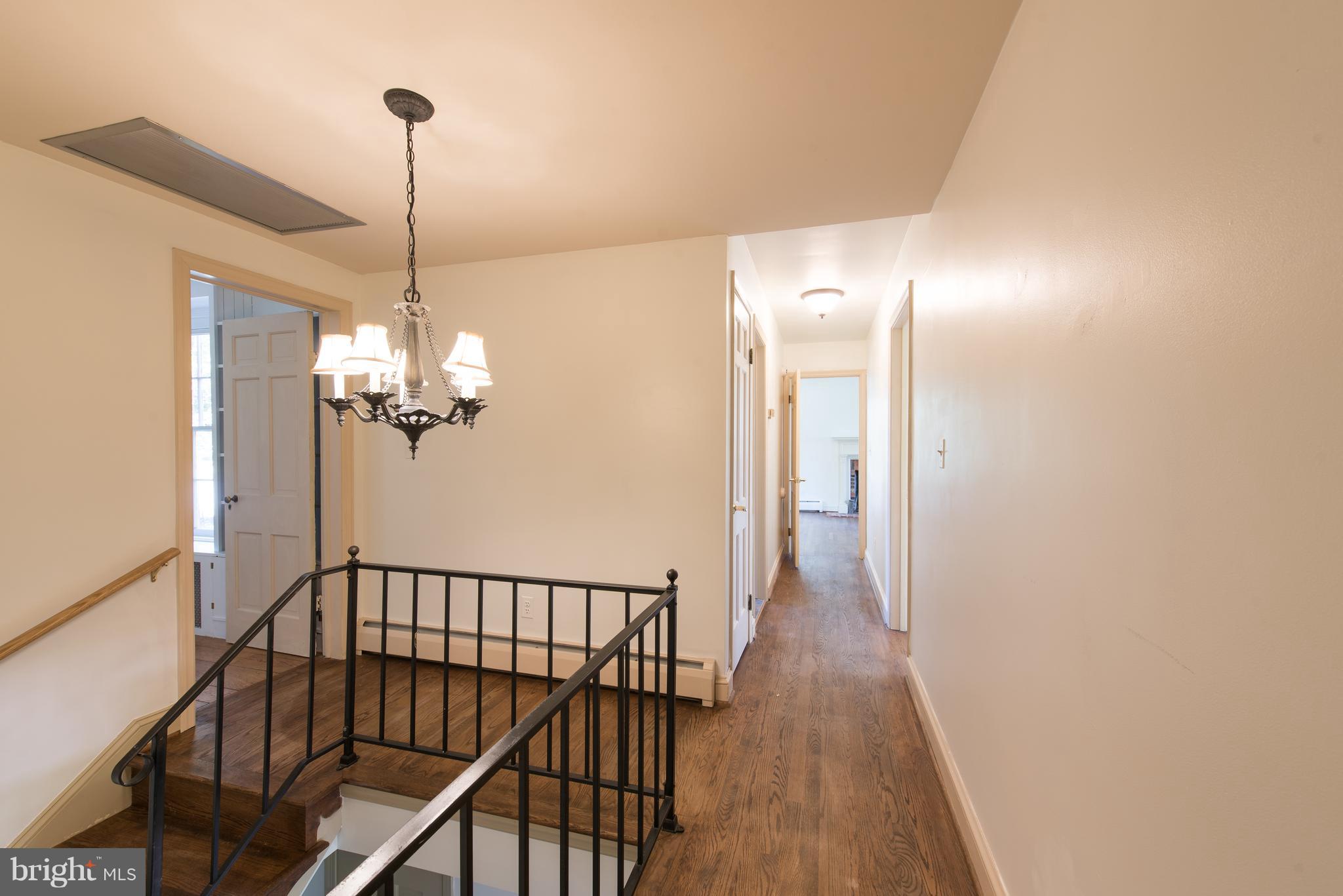 3645 Macalpine Road Ellicott City, MD 21042 - Photo 17 of 30 a view of a hallway with a chandelier