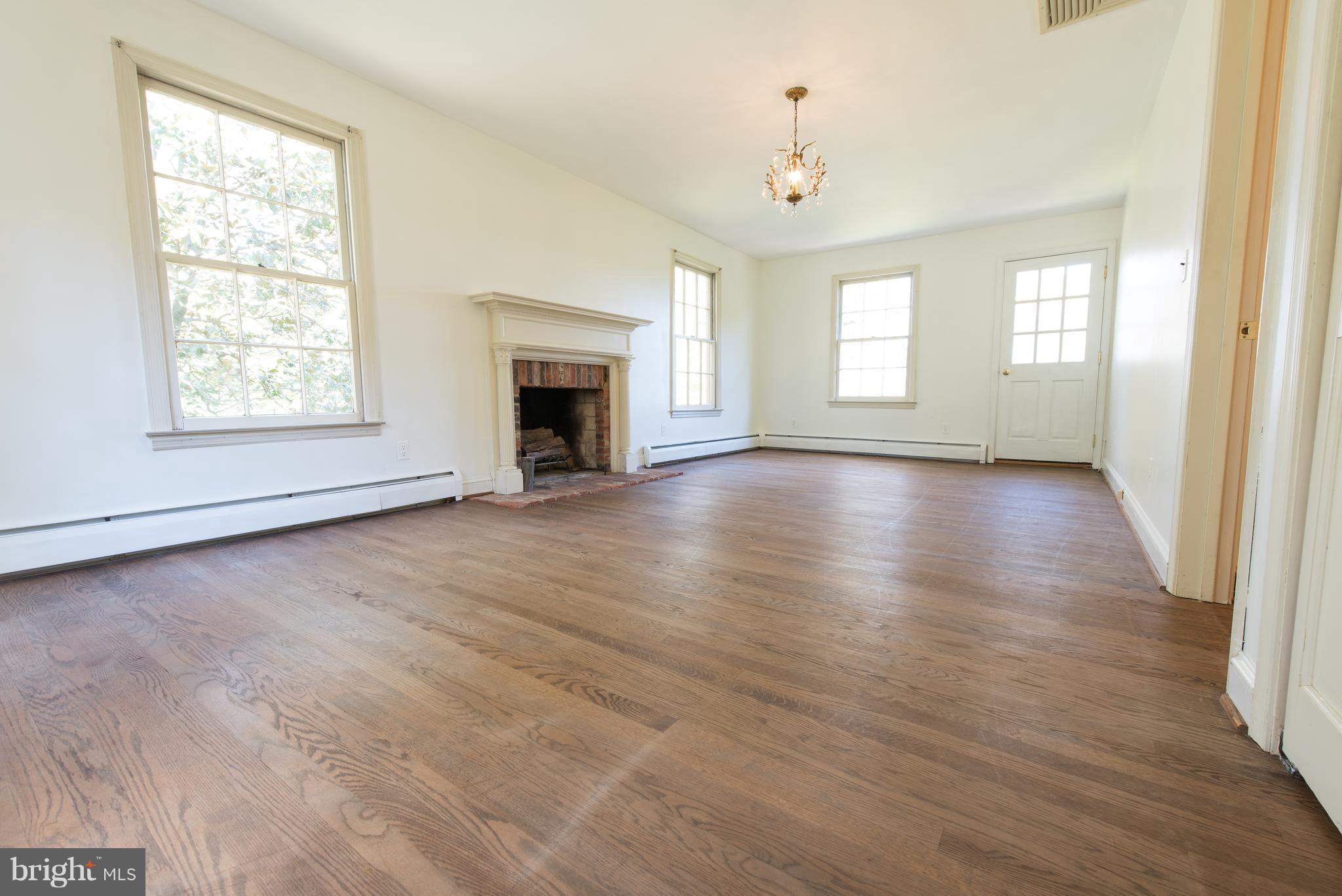 3645 Macalpine Road Ellicott City, MD 21042 - Photo 18 of 30 an empty room with wooden floor fireplace and windows
