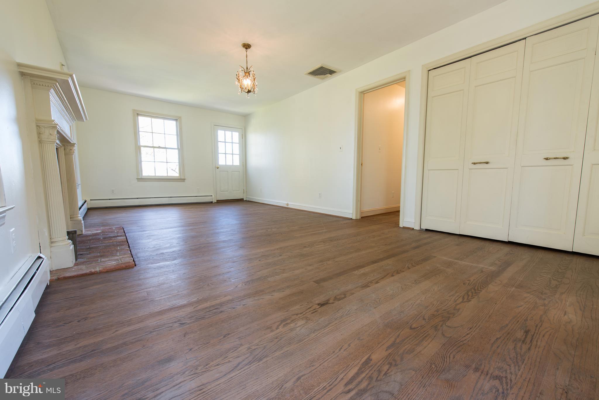 3645 Macalpine Road Ellicott City, MD 21042 - Photo 19 of 30 a view of an empty room with wooden floor and a window