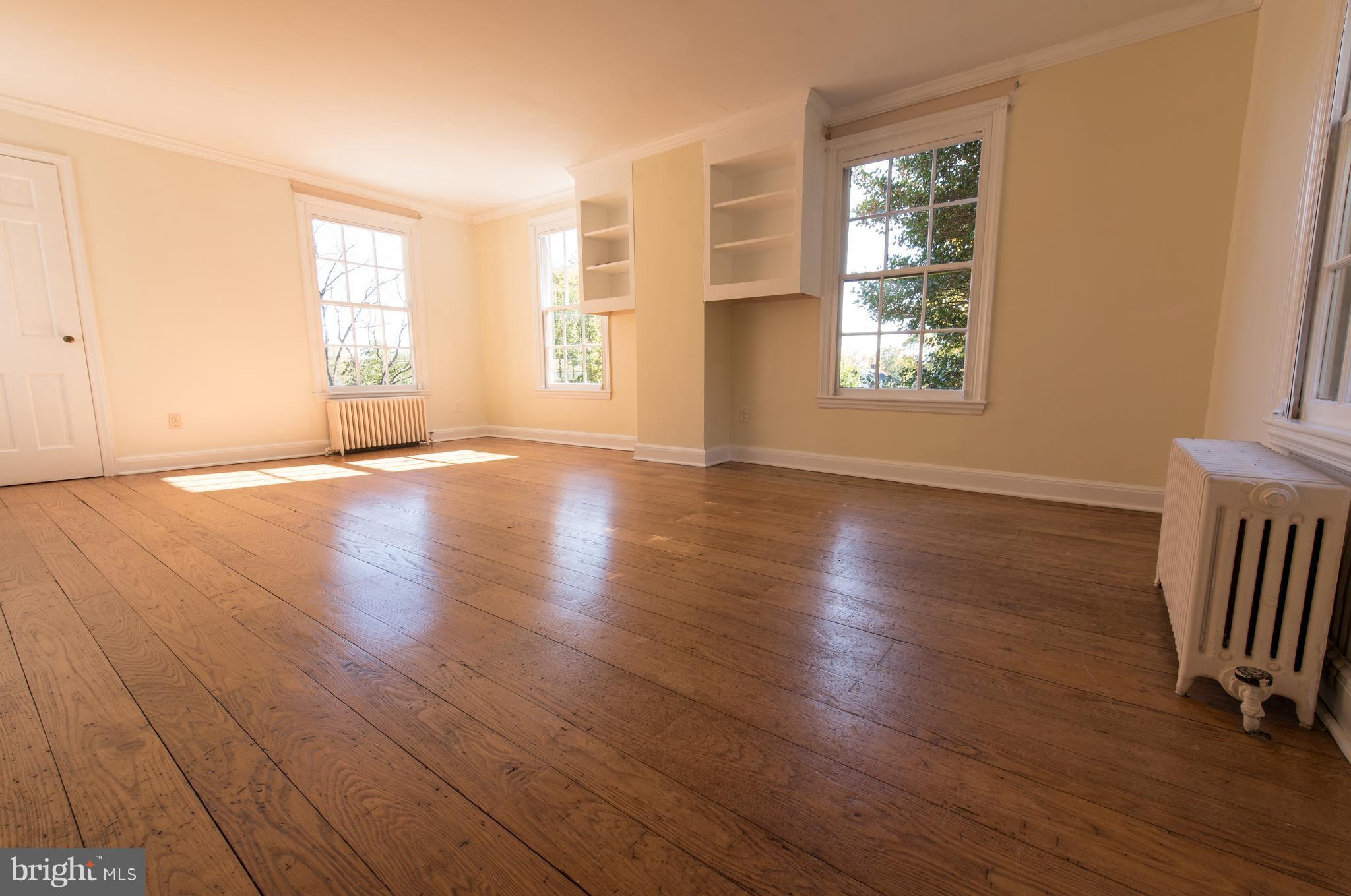 3645 Macalpine Road Ellicott City, MD 21042 - Photo 22 of 30 an empty room with wooden floor and windows