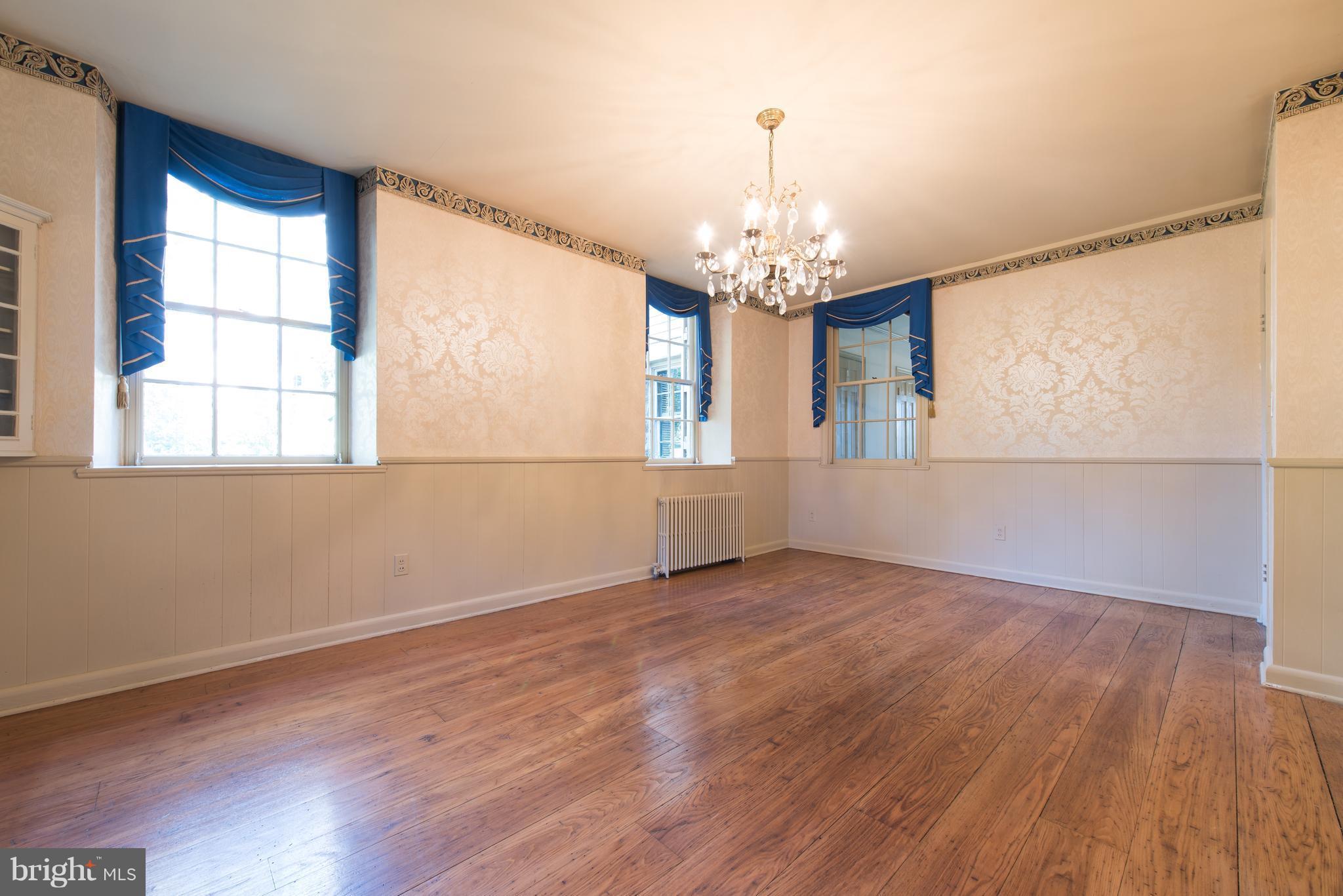 3645 Macalpine Road Ellicott City, MD 21042 - Photo 7 of 30 an empty room with wooden floor chandelier and windows