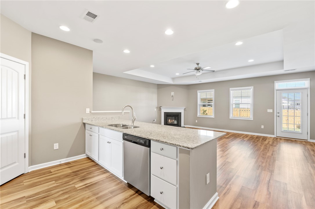 127 Spyglass Lane Pendleton, SC 29670 - Photo 26 of 45 Granite counters and wood floors anchor this seamless open layout leading to the living area.