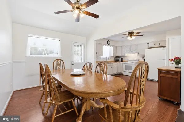 a dining room with furniture and wooden floor