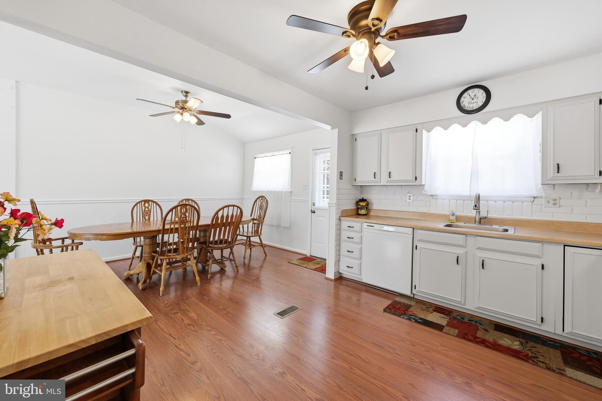 55 Plymouth Road Hammonton, NJ 08037 - Photo 18 of 45 a open kitchen with stainless steel appliances granite countertop a stove a sink a dining table and chairs with wooden floor