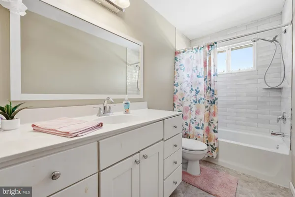 a bathroom with a sink a toilet and a bathtub