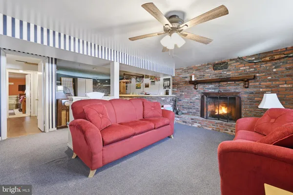 a living room with furniture a fireplace and a chandelier