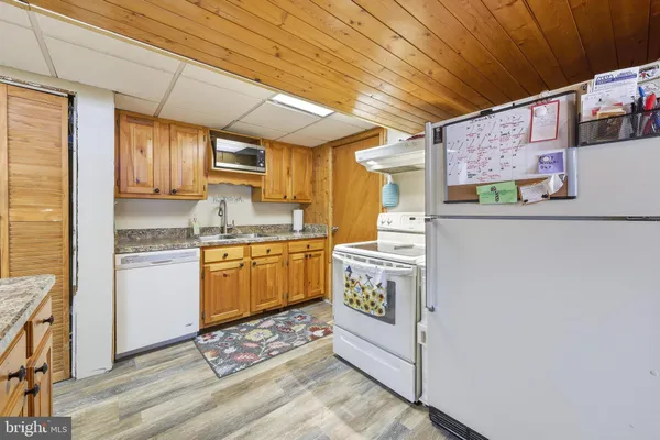 a kitchen with cabinets and wooden floor
