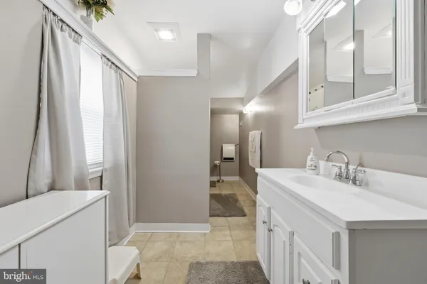 a bathroom with a sink a mirror and a shower