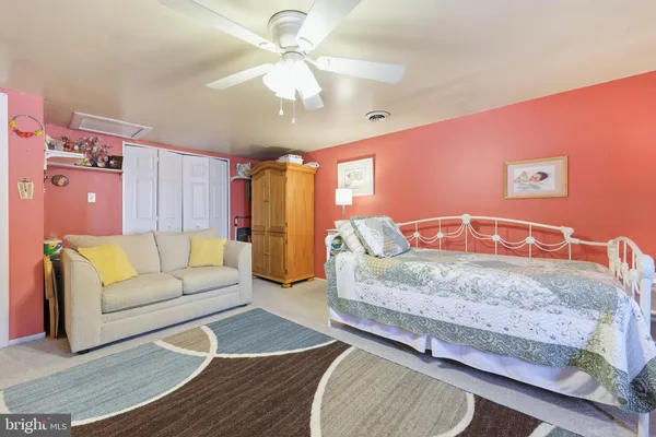 a bedroom with a bed couch and window