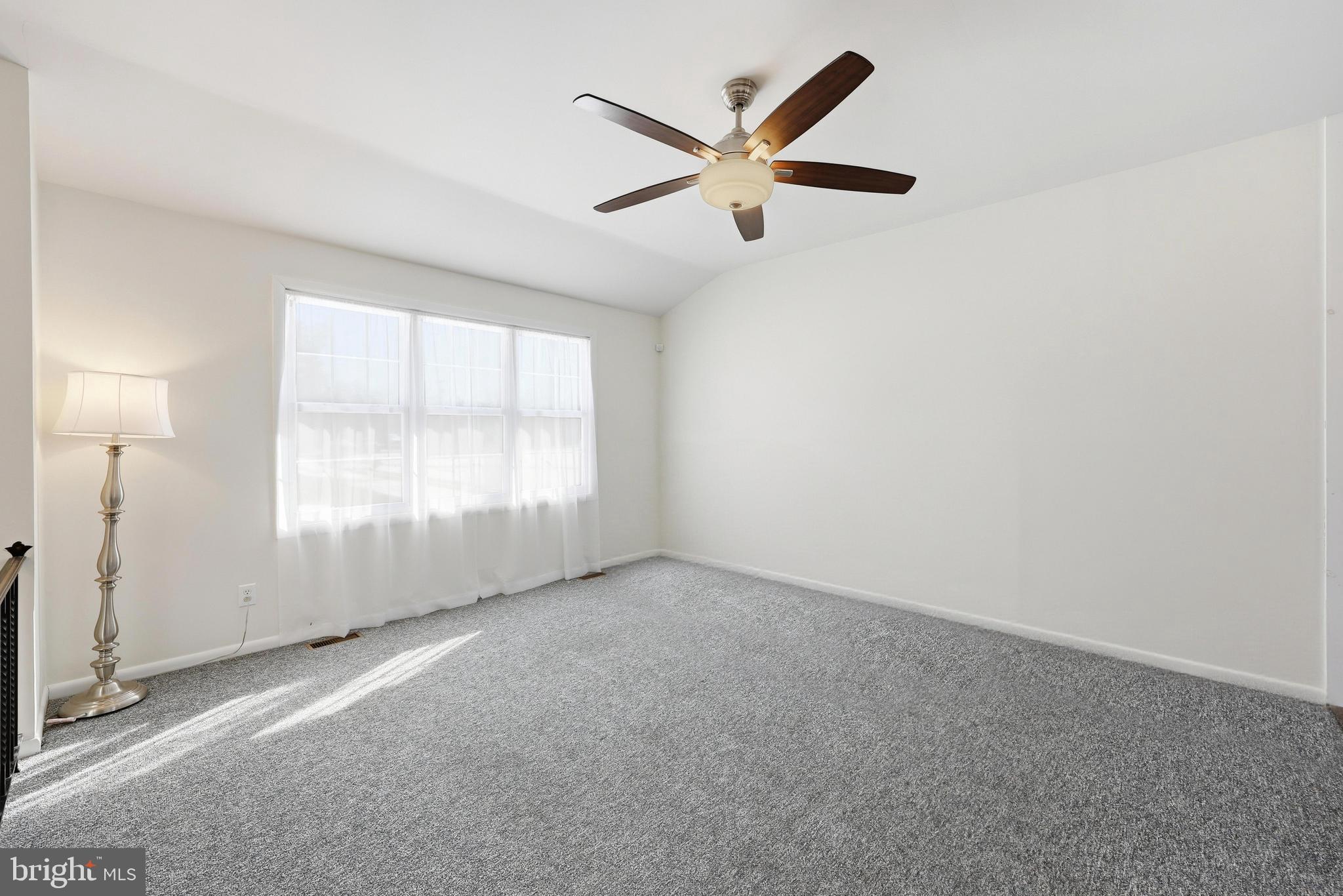 55 Plymouth Road Hammonton, NJ 08037 - Photo 10 of 45 an empty room with a ceiling fan and windows