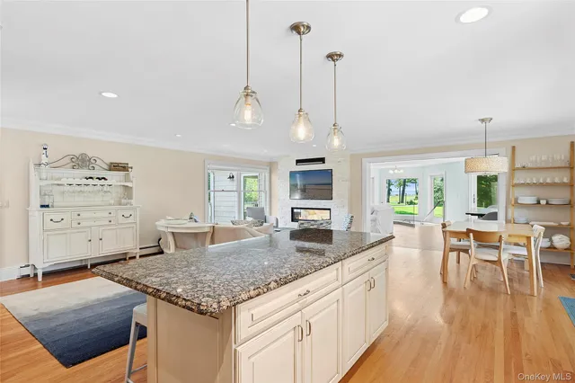 a kitchen with granite countertop kitchen island stainless steel appliances a table and chairs