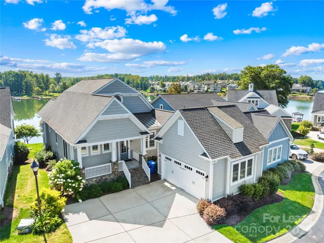 a aerial view of a house with a yard and potted plants