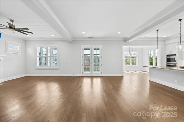 a view of a livingroom with wooden floor and a fireplace