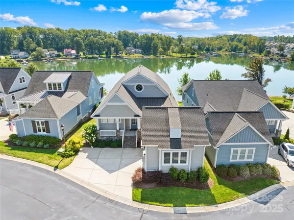 an aerial view of a house with outdoor space and lake view