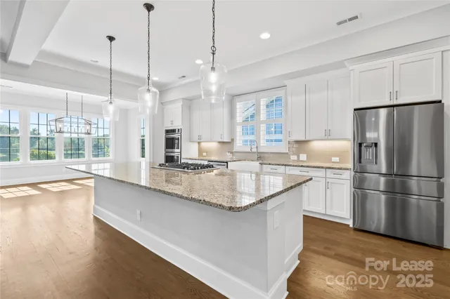a large kitchen with granite countertop a lot of counter space