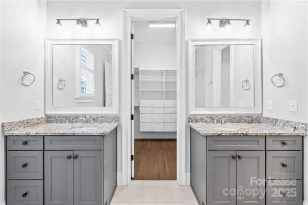 a bathroom with a granite countertop sink a toilet and shower