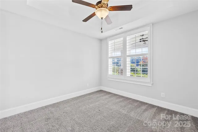 a bathroom with a granite countertop toilet a sink and a mirror