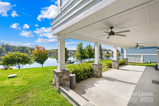 a view of a patio with couches and table and chairs and potted plants
