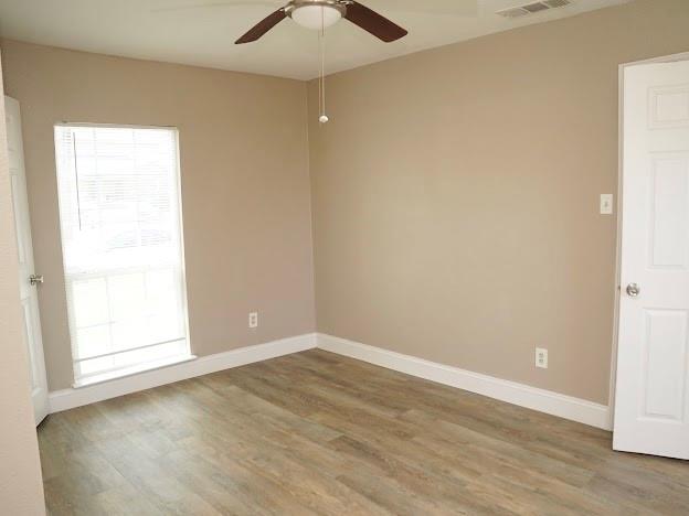 515 Taylor Street Arlington, TX 76011 - Photo 13 of 18 an empty room with wooden floor and windows