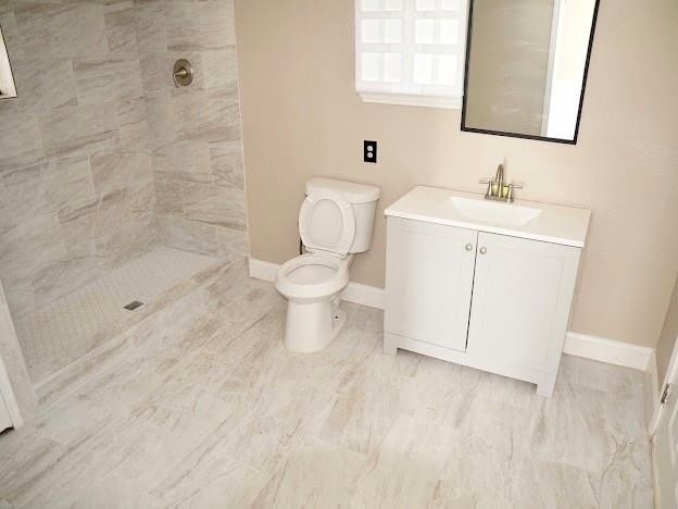 515 Taylor Street Arlington, TX 76011 - Photo 15 of 18 a white toilet sitting next to a bathroom sink