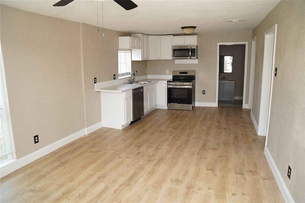 515 Taylor Street Arlington, TX 76011 - Photo 3 of 18 a view of a kitchen with a sink cabinets and a window