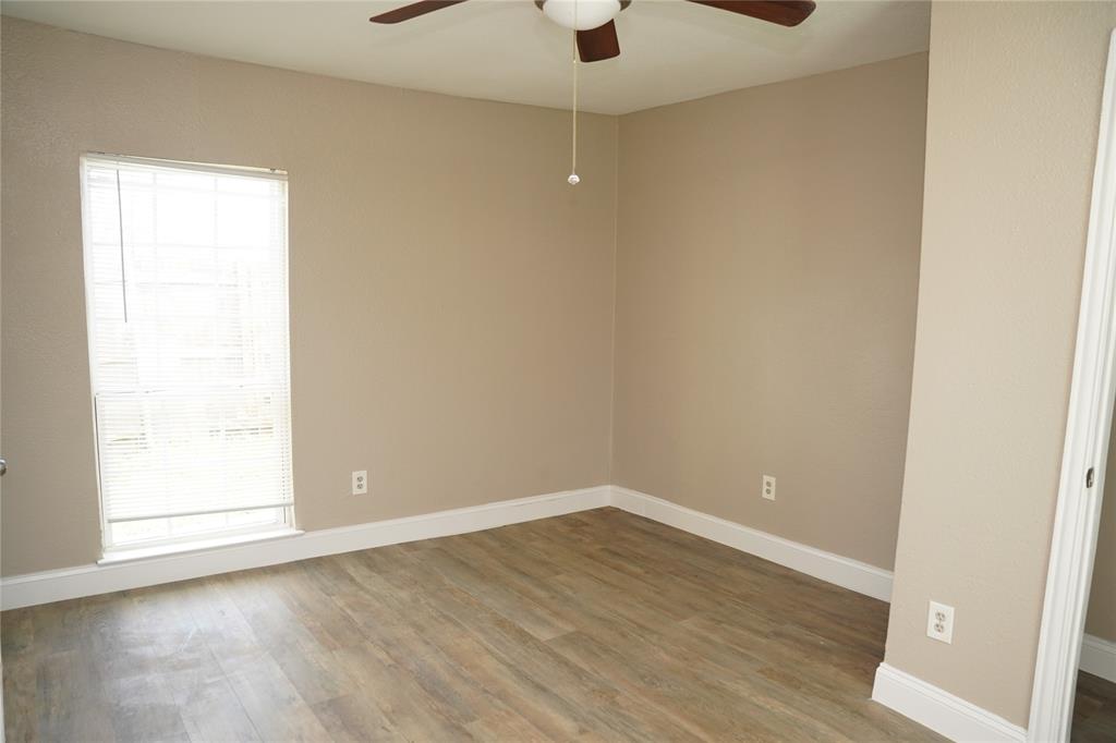 515 Taylor Street Arlington, TX 76011 - Photo 8 of 18 an empty room with wooden floor and windows