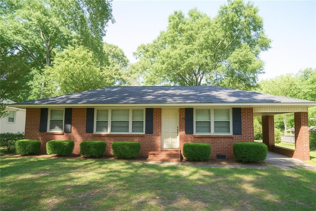 5530 Perry Avenue Columbus, GA 31909 - Photo 1 of 1 a view of a house with a yard plants and large tree