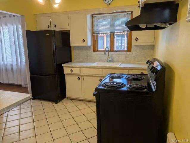 a kitchen with a refrigerator and a stove