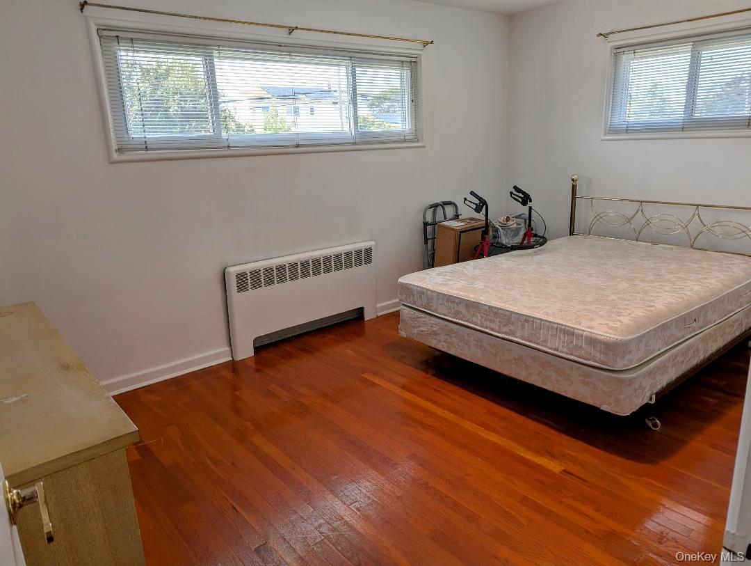 483 South Oyster Bay Road Plainview, NY 11803 - Photo 5 of 9 a bedroom with a bed and a window
