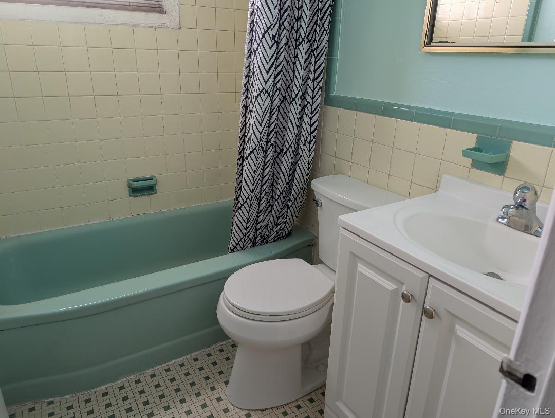 483 South Oyster Bay Road Plainview, NY 11803 - Photo 7 of 9 a bathroom with a sink toilet and shower