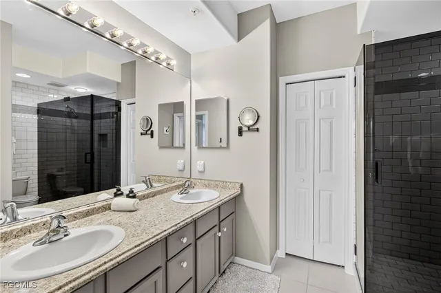 a bathroom with a double vanity sink and a mirror