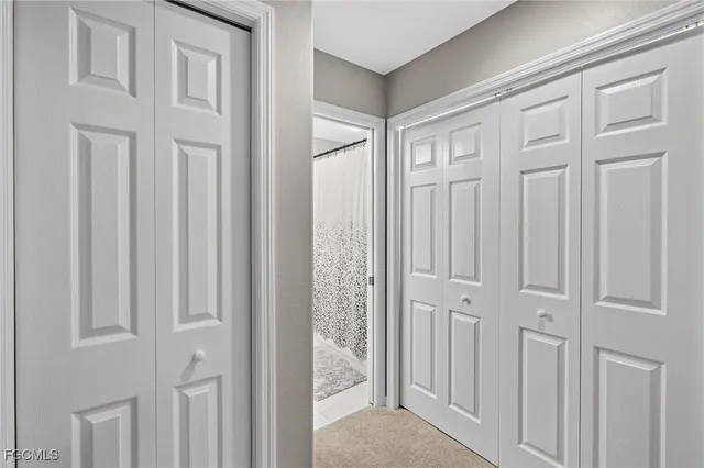a view of a hallway with white doors