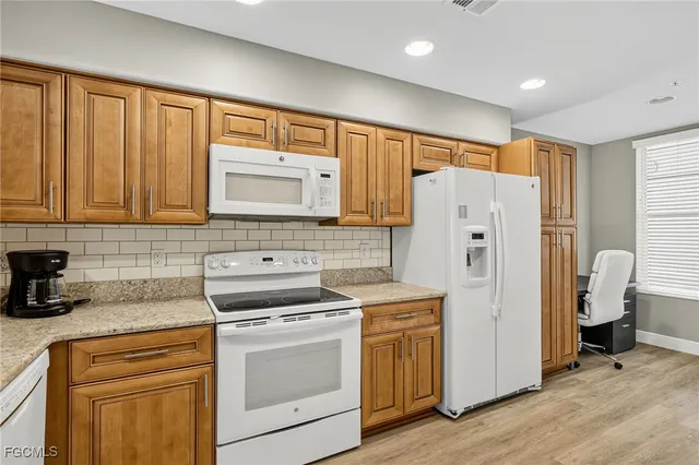 a kitchen with a refrigerator stove and sink