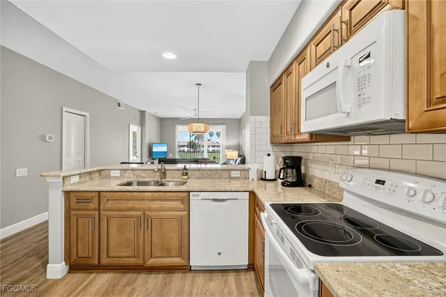 a kitchen with a sink a stove and cabinets