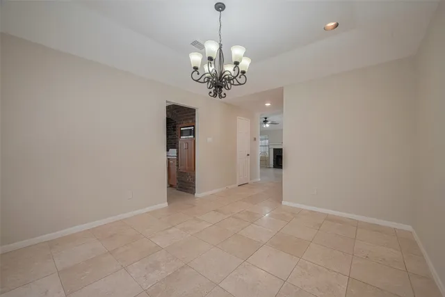a view of an empty room with a chandelier